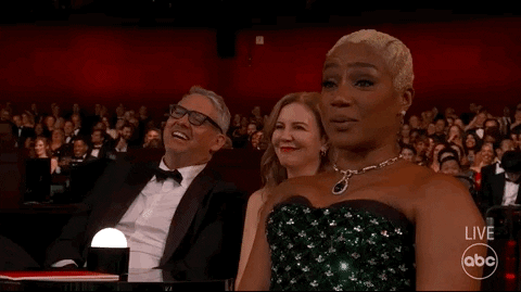Celebrity gif. Comedian Tiffany Haddish applauds and smiles in the audience at the 2022 Oscars. 