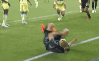 Sports gif. Walker Zimmerman from Nashville Soccer Club is on the field and he does a celebratory 2-fingered salute as he walks.