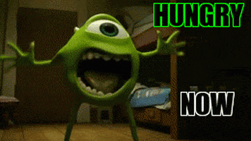 Movie gif. Mike Wazowski from Monsters Inc screams broadly, chest out, mouth wide open. Text, "hungry now."