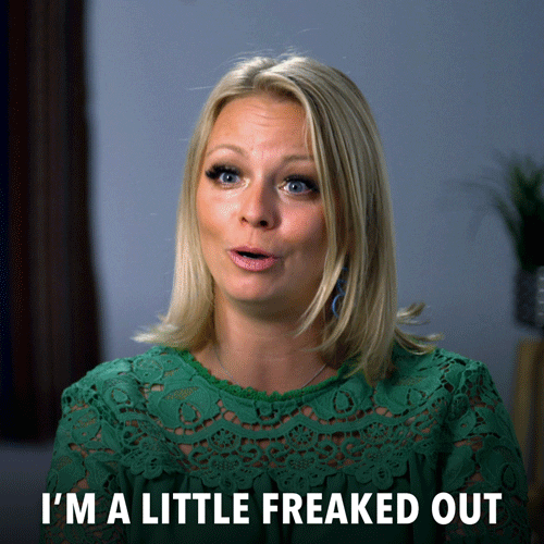 Reality TV gif. A woman from Married At First Sight is being interviewed and she looks scared and smiles nervously as she says "I'm a little freaked out!"