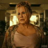 TV gif. Jennifer Coolidge as Tanya in The White Lotus appears sad as she asks, "Could I get some alcohol?"