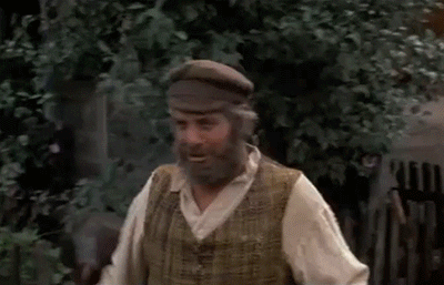 Movie gif. Chaim Topol as Tevye in Fiddler on the Roof walks down a road, holding a silver pot. He swings the pot up and rests it on a wall, and leans onto it. He looks at us, saying, “I'll tell you! I don't know.” and walks away. 