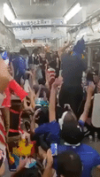 French Fan Crowd Surfs on Tokyo Subway Amid World Cup Celebrations
