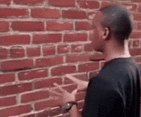 Rhyancm guy wall talking to the wall GIF
