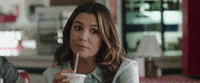 Movie gif. Eva Longoria as Theresa in Overboard looks at someone matter of factly and nods with a cup and straw to her mouth. 