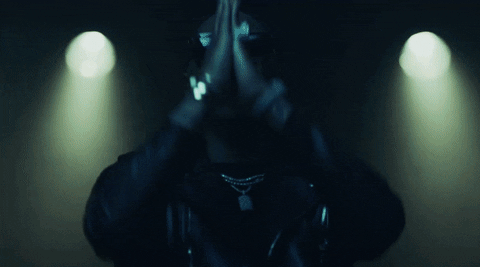 Music video gif. From the video for Wicked, Future presses his hands together in prayer in front of his face, and stage lights behind him flash forward, almost obscuring him.