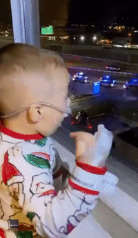 Two-Year-Old Greets Aerial-Ladder Santa From Hospital Window in West Virginia