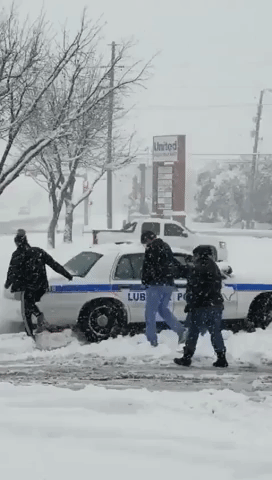 Passersby Help Push Texas Police Car Out of Snowy Parking Lot