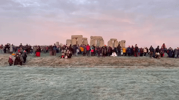 Crowds at Stonehenge Watch Sunrise on Winter Solstice