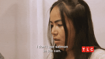 TV gif. A woman with long dark hair from 90 Day Fiance looks down and away from us, saying, "I don't use salmon in the can," which appears as text.