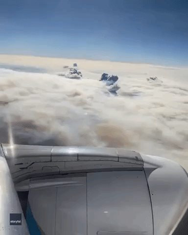 Smoke Plumes Penetrate Clouds as Plane Flies Above California's Dixie Fire
