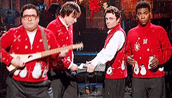 SNL gif. Horatio Sanz, Chris Kattan, Jimmy Fallon, and Tracy Morgan dance in a holiday-themed skit, all wearing red Christmas sweaters as snow falls around them. Sanz has a guitar-like instrument and Fallon holds a keyboard. We zoom in on Chris and Tracy exclusively, their expressions less than enthusiastic.