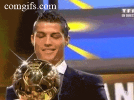 Sports gif. Cristiano Ronaldo wears a suits and holds a gleaming soccer ball trophy as he smiles and nods.
