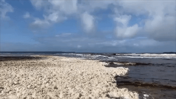Stormy Weather and Heavy Rainfall Whips Up Sea Foam at Huskisson Beach