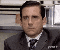 The Office gif. Steve Carell as Michael stares deadpan ahead, focus zooming in on his unthrilled face.