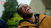 TV gif. Tom Moutchi from Famalam leans back and laughs hard.