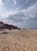 Beachgoers Run for Cover as Sirens Go Off in Tel Aviv
