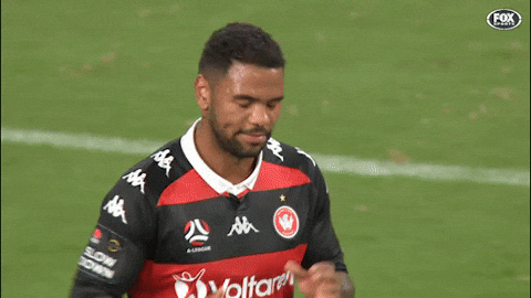 Sports gif. Kwame Yeboah jogs down a field and claps his hands, then high fives Bernie Ibini and hugs him as they both continue jogging.