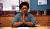 TV gif. Yvette Nicole Brown as Shirley in Community presses her hands together in prayer at a table, mouthing something with furrowed brows.