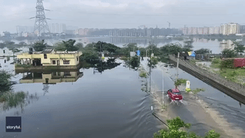 Cars Drive Through Inches of Floodwater in Chennai, India
