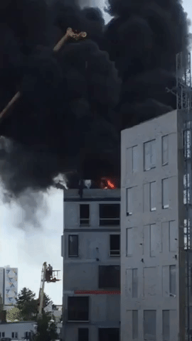 Man Escapes Burning Building by Holding on to Crane Hook