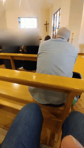 Churchgoer Sneakily Watches Soccer Game During Mass