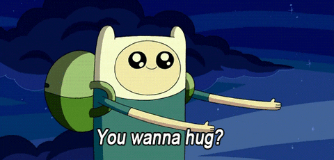 Cartoon gif. Finn in Adventure Time reaches out with both arms and gestures towards himself with his fingers as he says, "You wanna hug?"