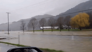 Motorists Drive Through Floodwaters Amid Evacuations in British Columbia