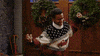 TV gif. Alfonso Ribeiro as Carlton in Fresh Prince of Bel-Air is doing his Carlton dance while wearing an ugly Christmas sweater.