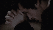 Movie gif. A close-up profile view of Jason Miller as Father Karras in The Exorcist as he prays, with his folded hands at his forehead.