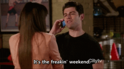 TV gif. Max Greenfield as Schmidt on New Girl is on the phone as he talks to Hannah Simone as CeCe in front of him. He lunges forward, tucking his bottom lip under his teeth to emphasize his gesture. "It's the freakin' weekend."