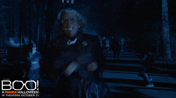 Ad gif. A movie trailer clip of Tyler Perry as Madea in BOO! A Madea Halloween. It's night time in the woods and she runs towards us screaming from being chased by humanoid monsters. Large text is superimposed over the screen three times in succession, "Help me Jesus!"