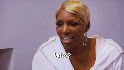 Reality TV gif. Nene Leakes on The Real Housewives of Atlanta sits slouched and then sits straight up in surprise.. She has a baffled expression on her face and she says, “Who?”