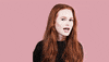 Celebrity gif. Madelaine Petsch winks at us emphatically with her head turned to the side.