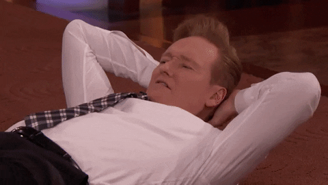 stretching jean-claude van damme GIF by Team Coco