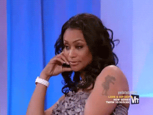 Reality TV gif. Tami Roman from Basketball Wives rests her head on her hand and gently rocks in annoyance with a serious expression.