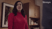 TV gif. Shannon Ross as Nicole Powers on Strays sighs in frustration as she fidgets her arms.