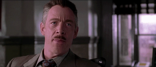 Movie gif. JK Simmons as Jonah and Tobey Maguire as Peter in Spider-Man. Jonah stares at Peter before laughing in his face, mocking and undermining him.