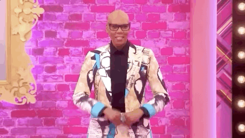 Reality TV gif. RuPaul from RuPaul's Drag Race gives us an excited set of finger guns, "Text, Go!!"