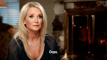 Reality TV gif. In a "confessional" segment from The Real Housewives, a blonde woman wearing a black top rolls her eyes, then speaks with a playful, falsely-nervous attitude. Text, "Oops."