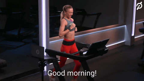 Video gif. Woman runs on treadmill at a pretty fast pace. She looks up at us and says, “Good morning! Happy Thursday!”