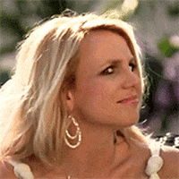 Celebrity gif. Britney Spears slowly turns her head towards us with confused wide eyes.
