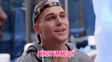 Reality TV gif. Man from Ex on the Beach wearing a camo backwards baseball cap smiles and glances over and says, "I know I'm messy," which appears as text.