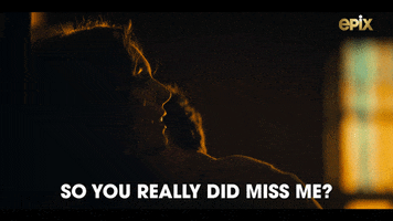Video gif. 2 young people hold each other in the dark as one of them asks, "Did you really miss me?"