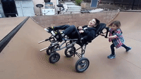 Sister and Wheelchair-Using Brother Try to Catch S