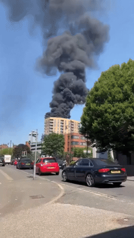 Smoke Billows From Apartment Block Rooftop