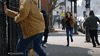 TV gif. A woman wearing a badge in Chicago PD runs down a city sidewalk with a badge hanging from her jeans as people around her run away in the opposite direction.
