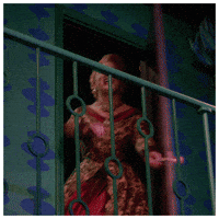 Celebrity gif. Jinkx Monsoon in the Jinkx and Dela Holiday Show swings a door open and stops abruptly, looking at us in a surprised hello.