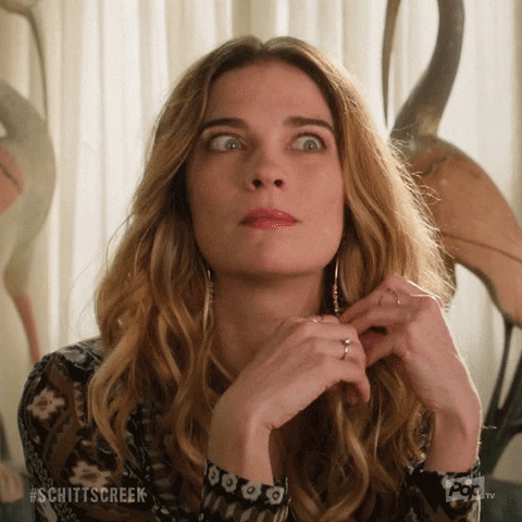 Schitt's Creek gif. Annie Murphy as Alexis fidgets with her hair, twirling it and looking up nervously, wide-eyed, while saying, "My god!" which appears as text.