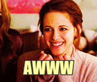 Movie gif. Kristen Stewart covers her mouth in a cute surprise. Text, "Awww."